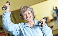 senior using hand weights